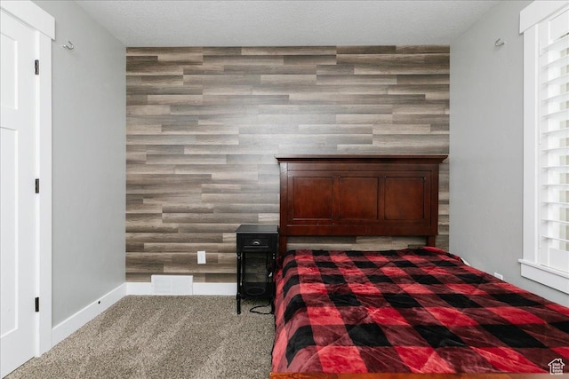 unfurnished bedroom featuring a textured ceiling and carpet