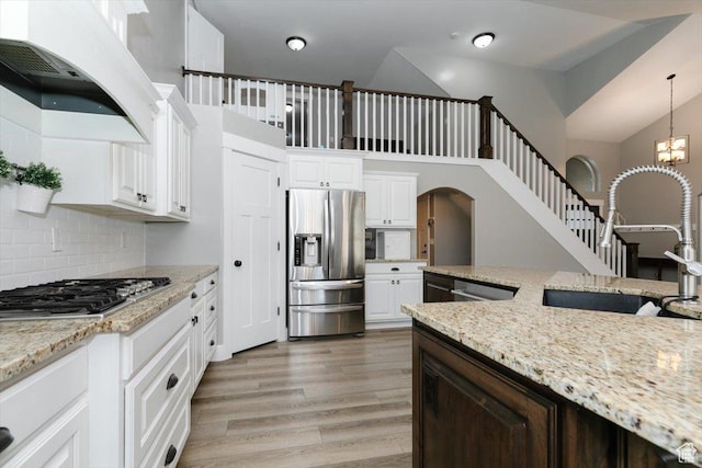 kitchen featuring hanging light fixtures, white cabinetry, appliances with stainless steel finishes, and sink