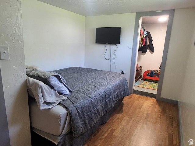 bedroom with wood finished floors