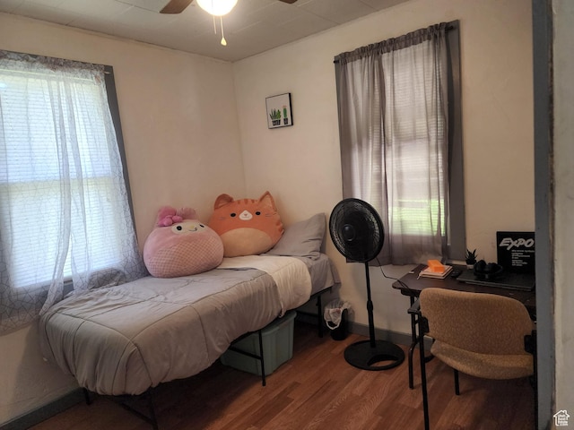 bedroom featuring baseboards, a ceiling fan, and wood finished floors