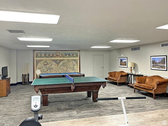 recreation room with hardwood / wood-style floors, pool table, and a textured ceiling