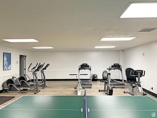workout area with wood-type flooring