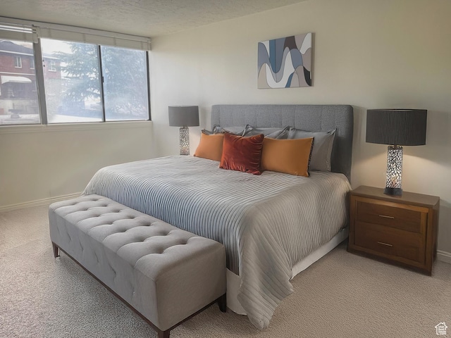 carpeted bedroom with a textured ceiling