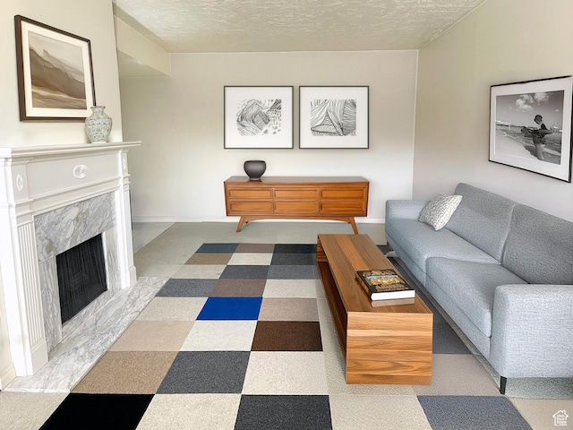 living room with a premium fireplace and a textured ceiling