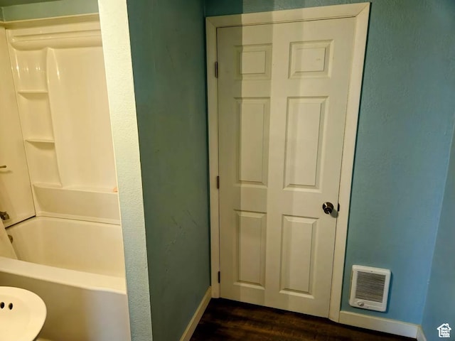 928 Monroe St, Montpelier, ID 83254 - bathroom featuring hardwood / wood-style flooring and shower / bathtub combination