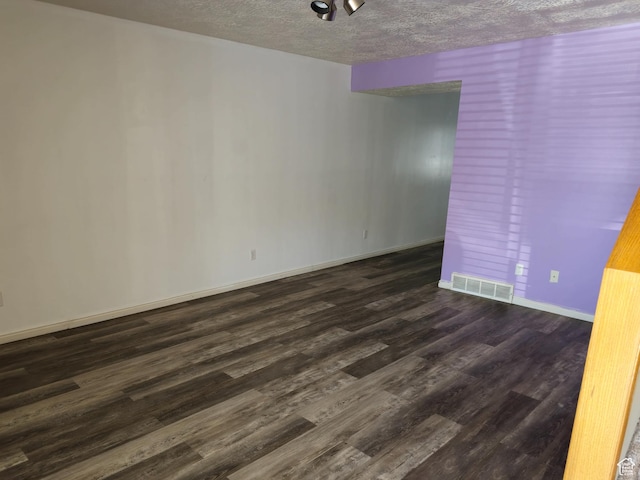 1305 Monroe Blvd Unit 15, Ogden, UT 84404 - empty room featuring a textured ceiling, dark wood-style flooring, visible vents, and baseboards