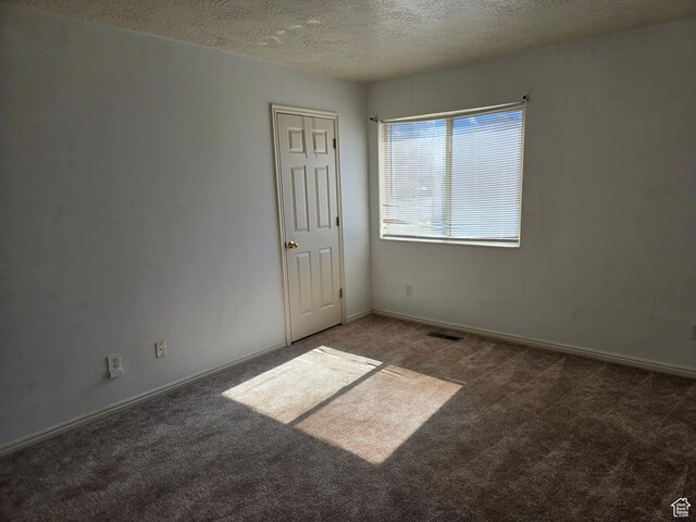 1305 Monroe Blvd Unit 15, Ogden, UT 84404 - spare room with carpet floors, visible vents, a textured ceiling, and baseboards