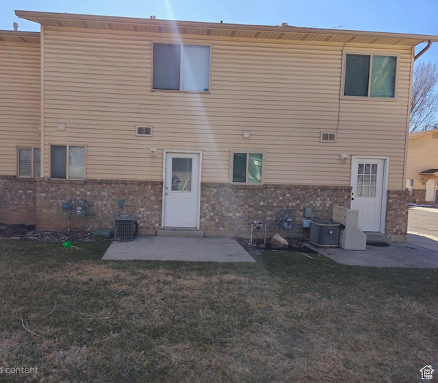 1305 Monroe Blvd Unit 15, Ogden, UT 84404 - rear view of property featuring a patio, a yard, and brick siding