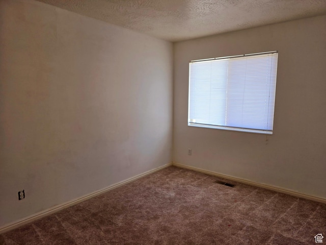 1305 Monroe Blvd Unit 15, Ogden, UT 84404 - spare room featuring carpet, visible vents, a textured ceiling, and baseboards