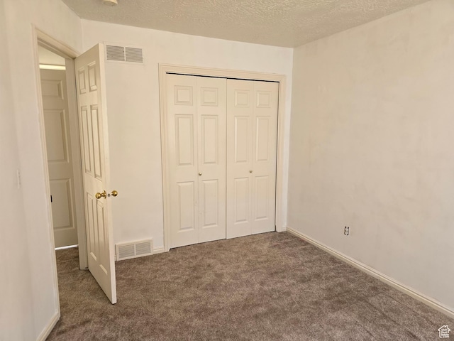 1305 Monroe Blvd Unit 15, Ogden, UT 84404 - unfurnished bedroom featuring a textured ceiling, a closet, carpet flooring, and visible vents
