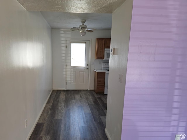 1305 Monroe Blvd Unit 15, Ogden, UT 84404 - kitchen featuring a textured ceiling, white appliances, dark wood-type flooring, baseboards, and brown cabinetry