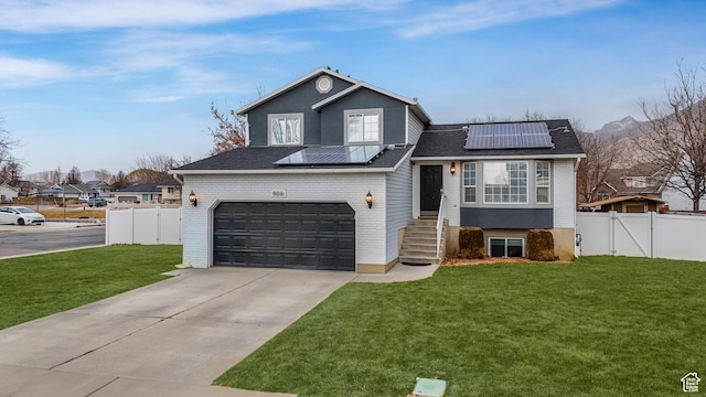 view of front facade featuring a front lawn and solar panels