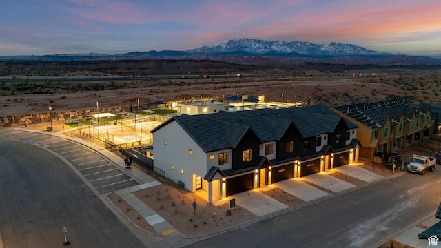 aerial view at dusk featuring a mountain view