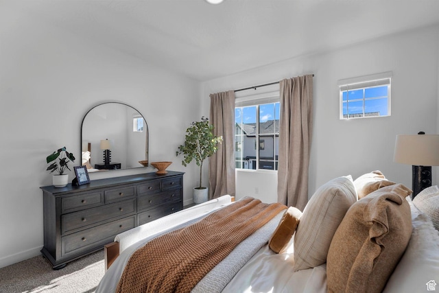 bedroom featuring baseboards and carpet flooring