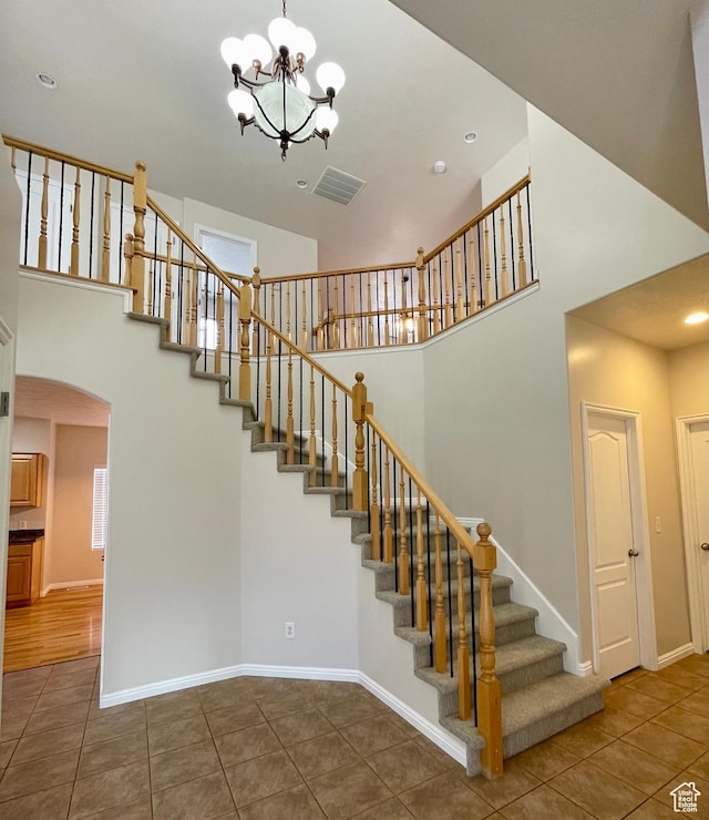 909 E Rosebud Ct, Draper, UT 84020 - stairway featuring a notable chandelier, a towering ceiling, and tile patterned floors