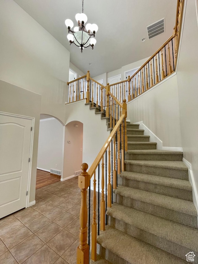 909 E Rosebud Ct, Draper, UT 84020 - stairs featuring a notable chandelier, tile patterned floors, and a high ceiling