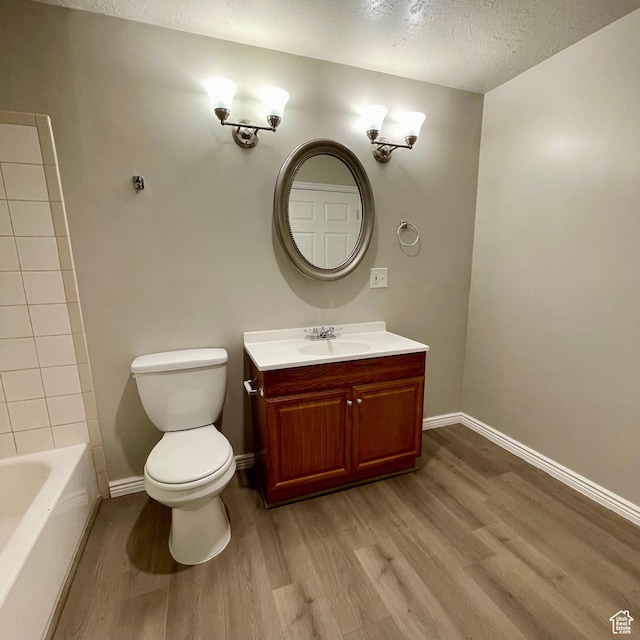 909 E Rosebud Ct, Draper, UT 84020 - bathroom with vanity, hardwood / wood-style floors, a textured ceiling, and toilet