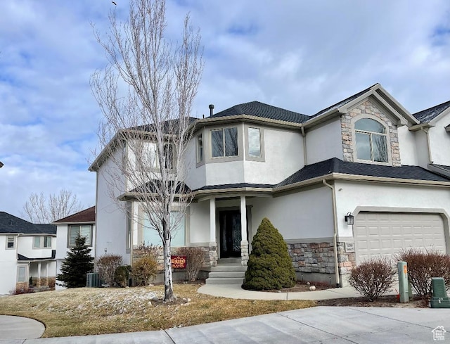 front of property with a garage and central AC unit