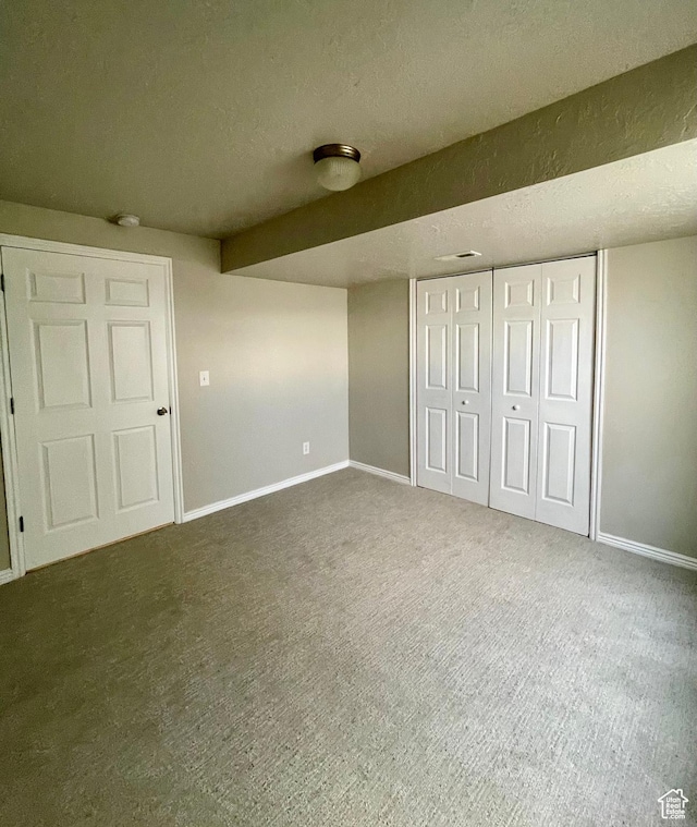 909 E Rosebud Ct, Draper, UT 84020 - unfurnished bedroom featuring a closet, a textured ceiling, and dark colored carpet
