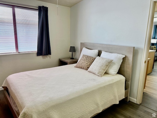 1150 W Red Hills Pkwy Unit 72, Washington, UT 84780 - bedroom with baseboards, ensuite bathroom, wood finished floors, and multiple windows