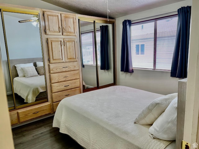 1150 W Red Hills Pkwy Unit 72, Washington, UT 84780 - bedroom featuring a textured ceiling, dark wood finished floors, and lofted ceiling