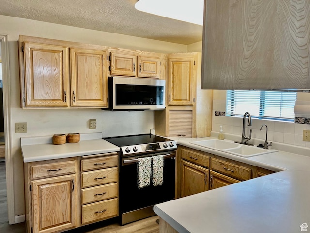 1150 W Red Hills Pkwy Unit 72, Washington, UT 84780 - kitchen featuring tasteful backsplash, a sink, light countertops, light brown cabinets, and stainless steel appliances
