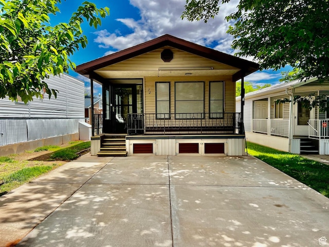 1150 W Red Hills Pkwy Unit 72, Washington, UT 84780 - shotgun-style home featuring covered porch, an attached garage, stairway, and driveway