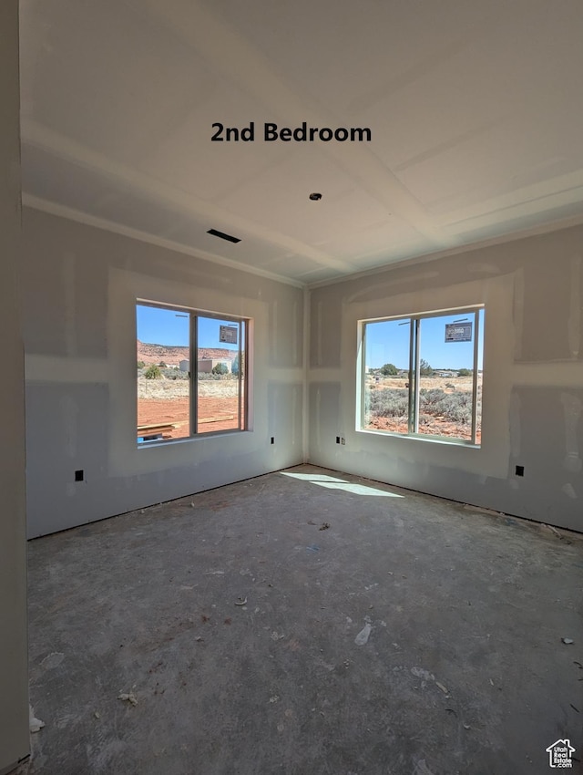 unfurnished room featuring visible vents