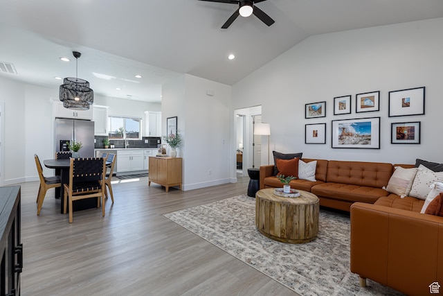 living area with light wood-style flooring, baseboards, visible vents, recessed lighting, and a ceiling fan