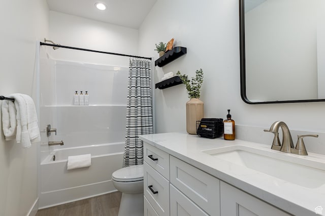 bathroom featuring toilet, recessed lighting, shower / bath combo with shower curtain, wood finished floors, and vanity