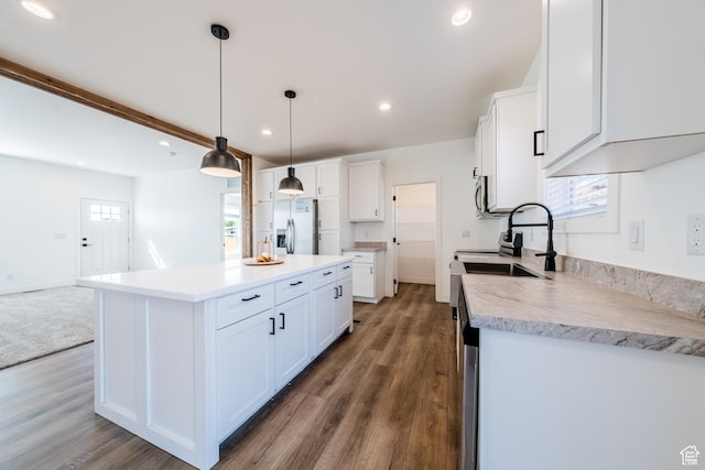 484 W Pipe Springs Dr, Kanab, UT 84741 - kitchen with dark hardwood / wood-style floors, white cabinetry, hanging light fixtures, a center island, and stainless steel appliances