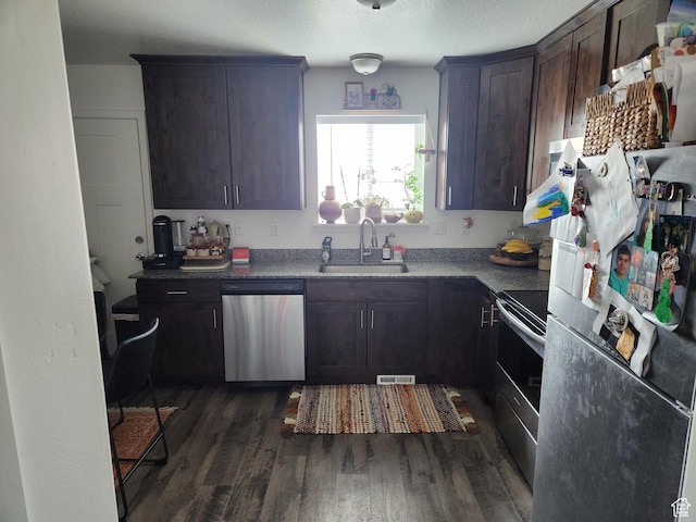 605 N Kay Ln, Tooele, UT 84074 - kitchen featuring dark brown cabinetry, stainless steel appliances, dark hardwood / wood-style floors, and sink