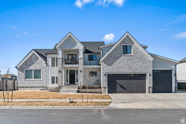 view of front of property with driveway, board and batten siding, fence, and a balcony