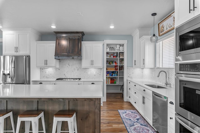 1426 S 1450 W, Mapleton, UT 84664 - kitchen featuring white cabinets, custom range hood, appliances with stainless steel finishes, a kitchen bar, and a sink