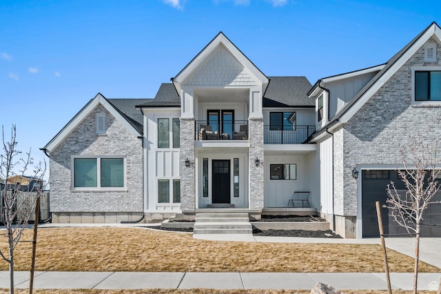 1426 S 1450 W, Mapleton, UT 84664 - view of front of property featuring a balcony, brick siding, a shingled roof, driveway, and board and batten siding