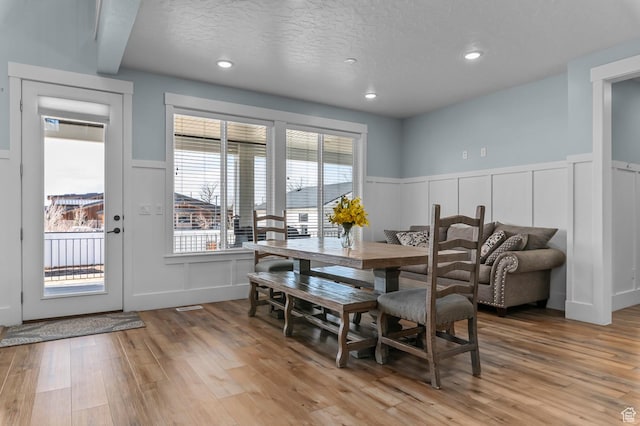 1426 S 1450 W, Mapleton, UT 84664 - dining room featuring wainscoting, a decorative wall, a textured ceiling, and light wood finished floors