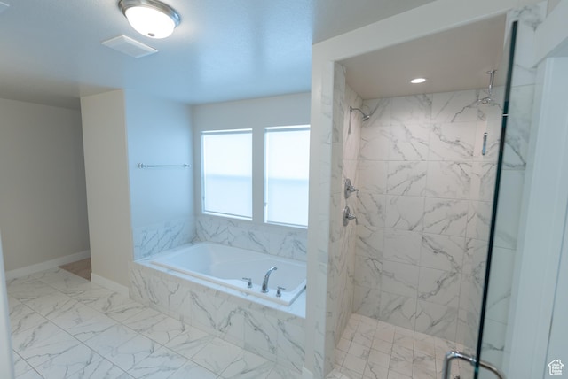 bathroom featuring a marble finish shower, a bath, marble finish floors, and baseboards