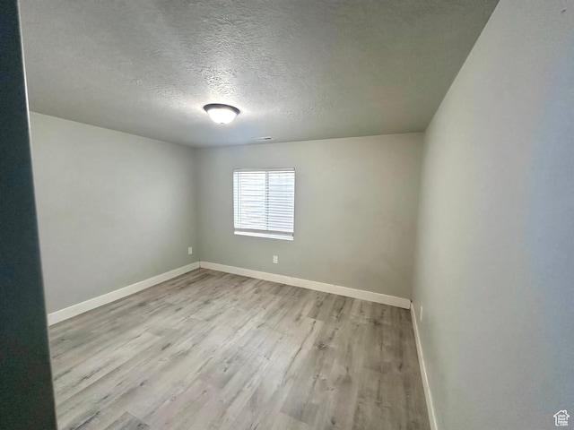 545 E Petersen Pkwy, South Weber, UT 84405 - unfurnished room with light wood-type flooring, visible vents, a textured ceiling, and baseboards
