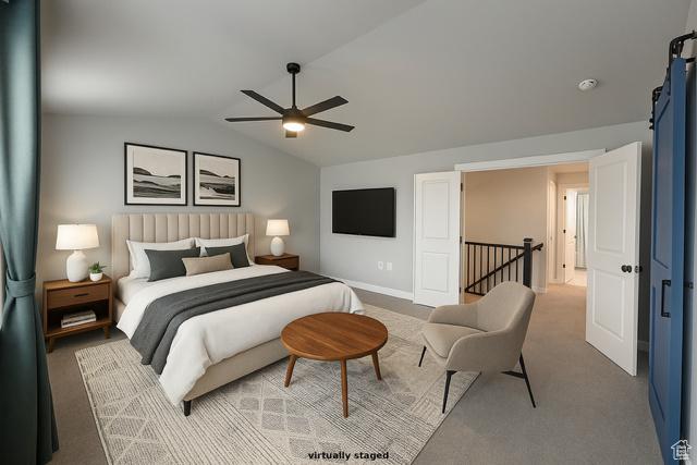 545 E Petersen Pkwy, South Weber, UT 84405 - bedroom with vaulted ceiling, a barn door, a ceiling fan, carpet, and baseboards