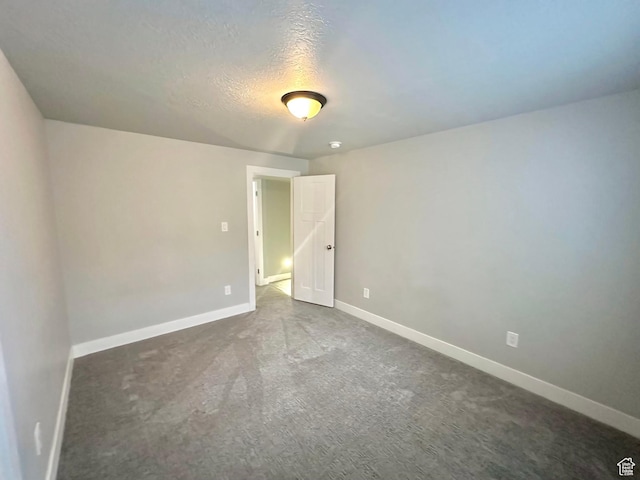 545 E Petersen Pkwy, South Weber, UT 84405 - spare room with baseboards, dark carpet, and a textured ceiling