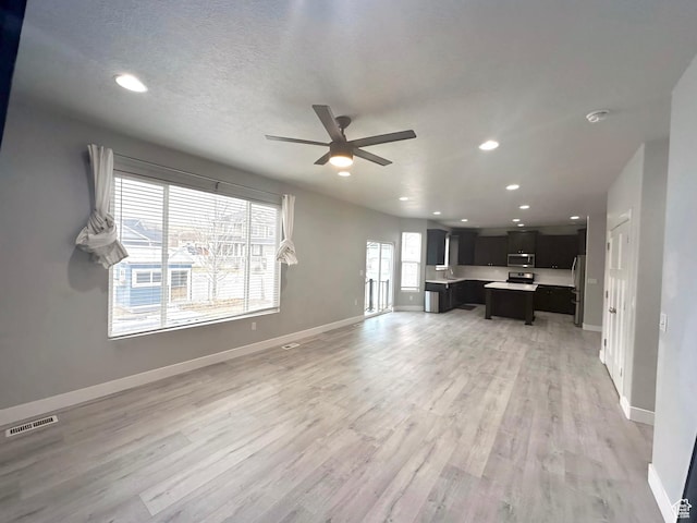 545 E Petersen Pkwy, South Weber, UT 84405 - unfurnished living room with ceiling fan, recessed lighting, visible vents, baseboards, and light wood finished floors