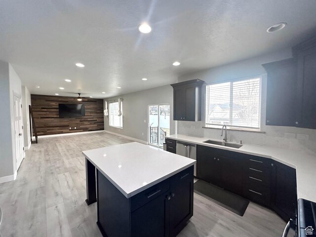 545 E Petersen Pkwy, South Weber, UT 84405 - kitchen with a sink, light countertops, wood walls, and a kitchen island