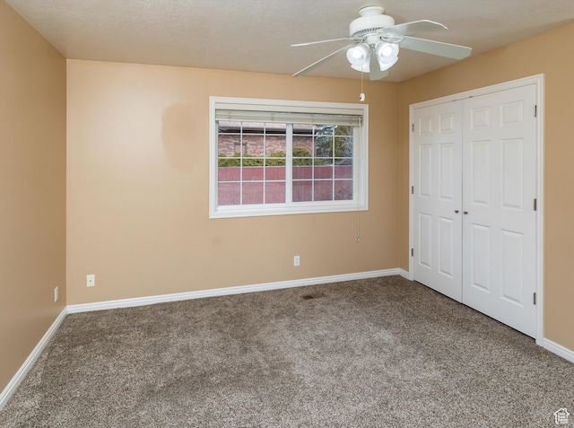 unfurnished bedroom featuring a closet, ceiling fan, and carpet