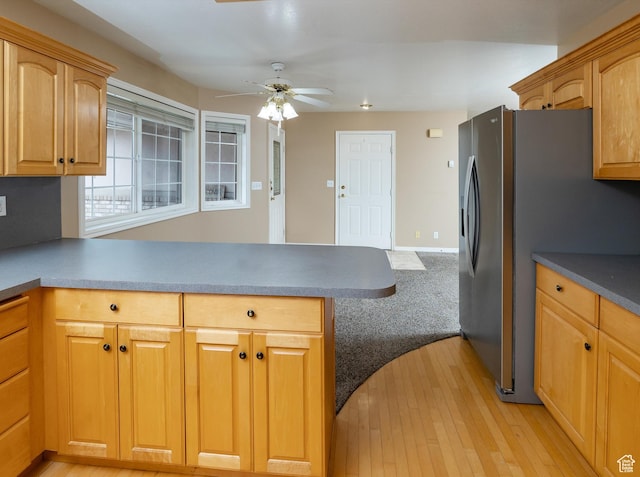kitchen with ceiling fan, stainless steel fridge, and light hardwood / wood-style flooring