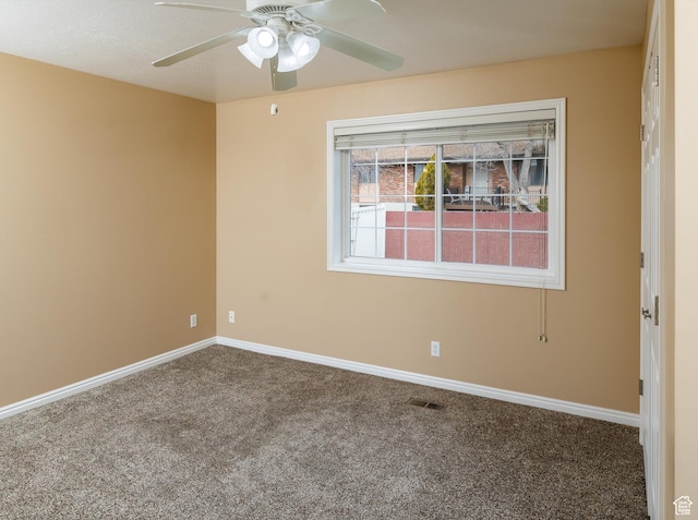 unfurnished room featuring ceiling fan and carpet