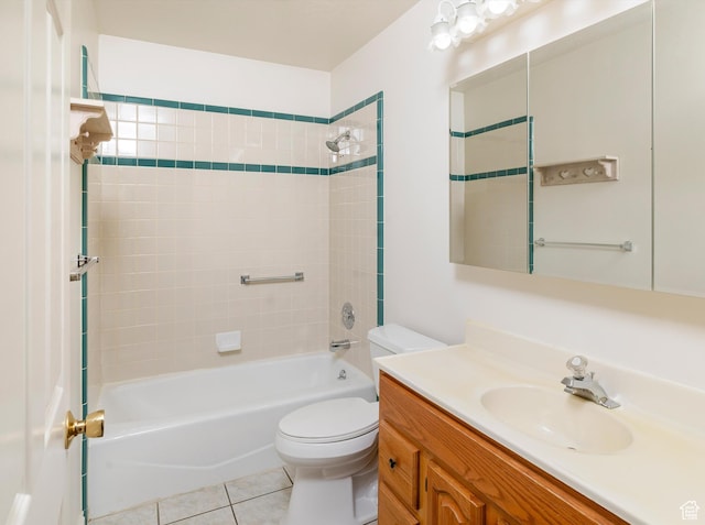 full bathroom featuring vanity, tiled shower / bath, tile patterned floors, and toilet