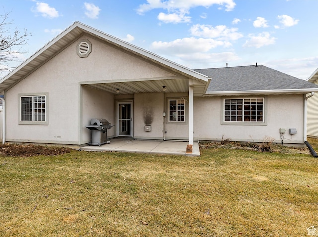 back of house with a yard and a patio area