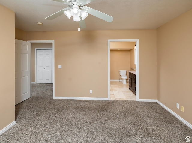 spare room featuring light colored carpet and ceiling fan