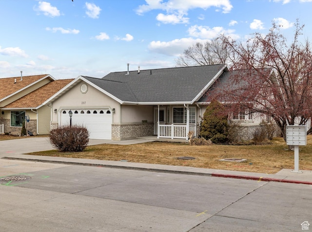 ranch-style home with a garage and covered porch