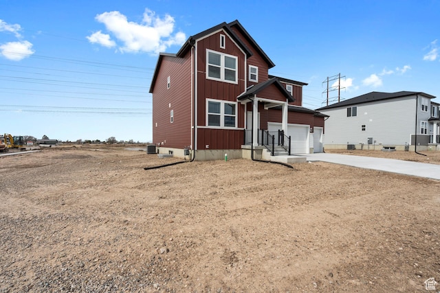 traditional-style home with driveway and board and batten siding